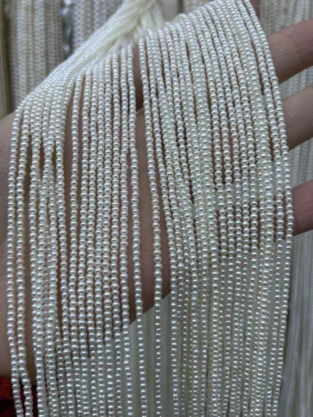 Natural freshwater pearl 2mm high quality pretty luster smooth surface white round strong bright pearl strands bulk sale