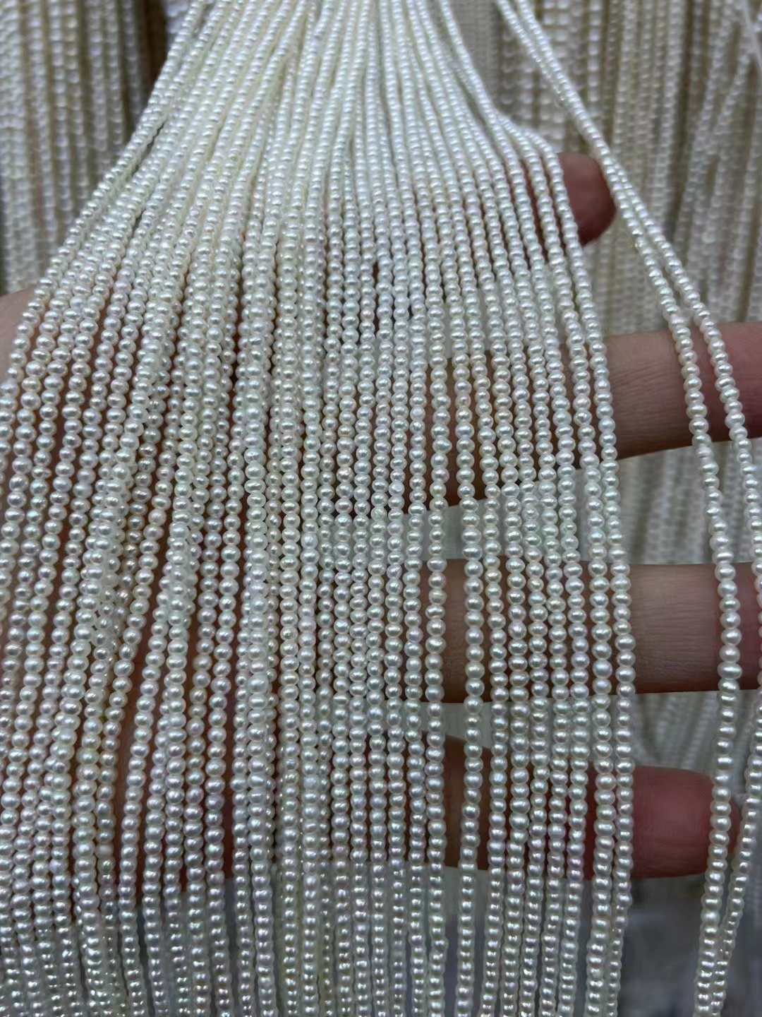 Natural freshwater pearl 2mm high quality pretty luster smooth surface white round strong bright pearl strands bulk sale